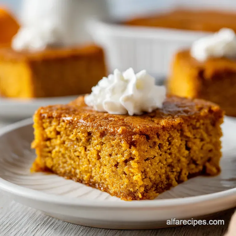 A single, perfect pumpkin bar with thick cream cheese frosting sits elegantly on a white plate.